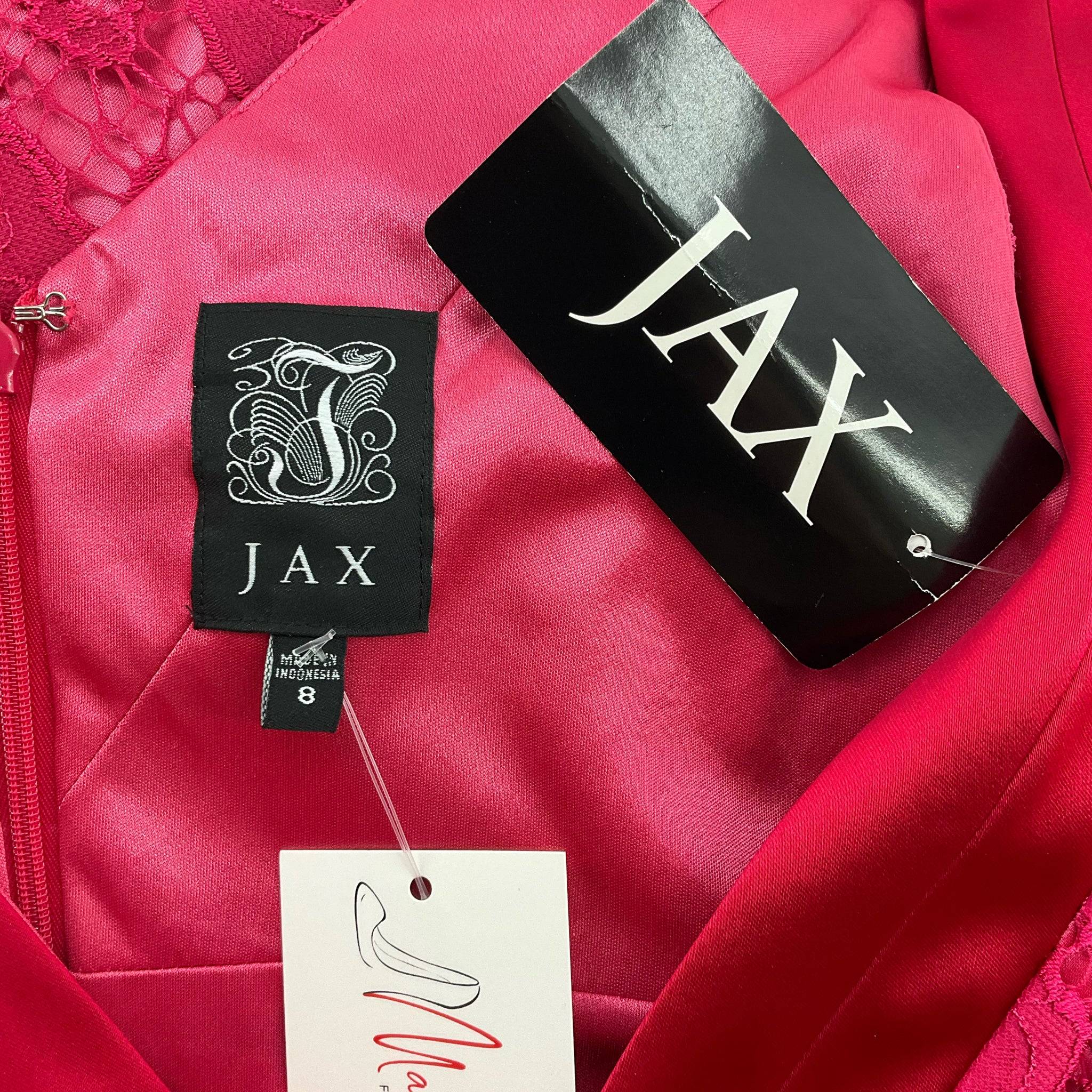 Close-up of Jax brand tags on pink lace V Neck Mini Dress Size 8, new with tags at Margaret’s Fine Consignments. Authentic designer cocktail dress.