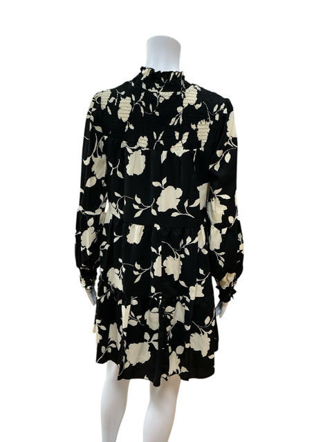 Back view of Anna Kaci black/cream print pre-owned ladies dress, size small, with long sleeves and smocked detailing, new with tags.