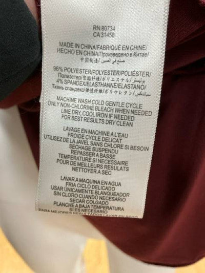 BCBG maroon solid ladies dress in size small, featuring a sleek design and elegant silhouette. Pre-owned condition.