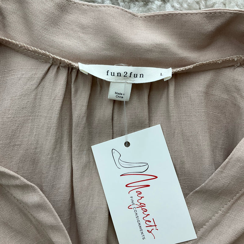 Close-up of Fun2Fun brand label on Tan Top, Size Large, confirming pre-owned status and stylish neutral tone.