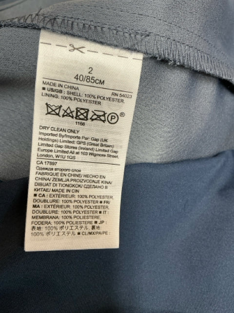 Close-up of care label on Banana Republic Blue Solid Pre-Owned Ladies Dress - Size 2, indicating 100% polyester and dry clean only.
