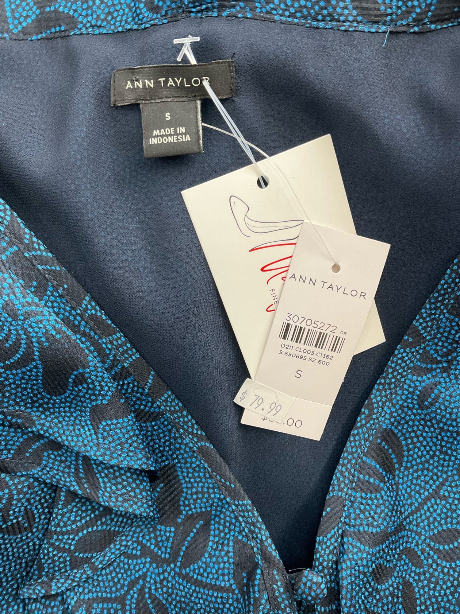 Ann Taylor pre-owned blue and black print blouse with tie-neck, ruffle details, and blouson sleeves, size small.