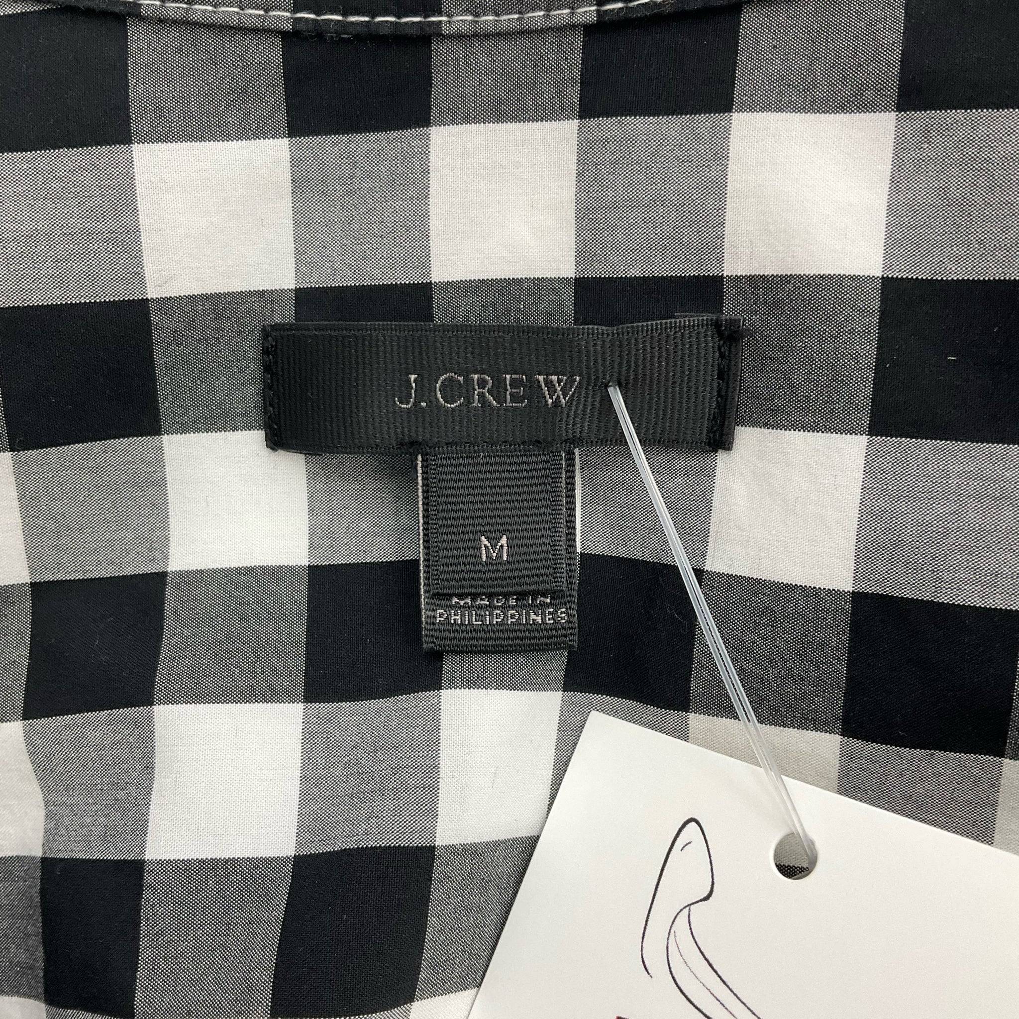 Close-up of J.Crew brand label on black and white checkered mini dress, Size Medium, offered by Margaret’s Fine Consignments.