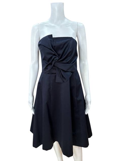 Front view of H & M Strapless Mini Dress Size 10 in navy on mannequin, featuring a knotted bodice, sold by Margaret’s Fine Consignments.