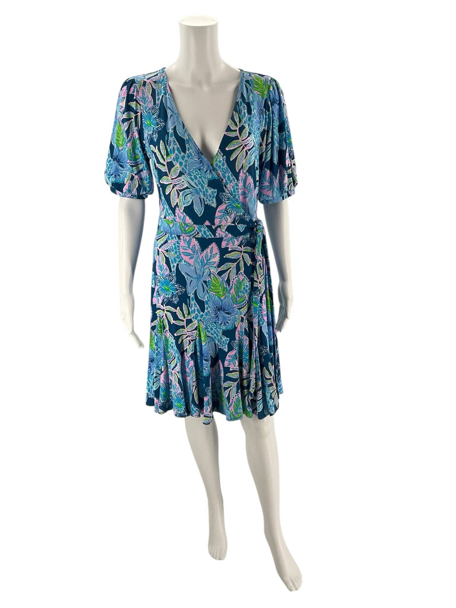Front view of Lilly Pulitzer Blue & Multi-Color Floral Dress – Size S on mannequin, showcasing wrap-style V-neck and vibrant floral print.
