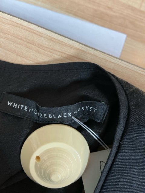 Brand label of White House Black Market on black fabric, confirming authenticity of the pre-owned size 8 floral sheath dress.