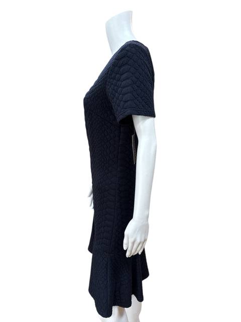 Side view of Sharagano Crew Neck Dress Size 10 on mannequin, highlighting textured navy fabric and short sleeve design at Margaret’s Fine Consignments.