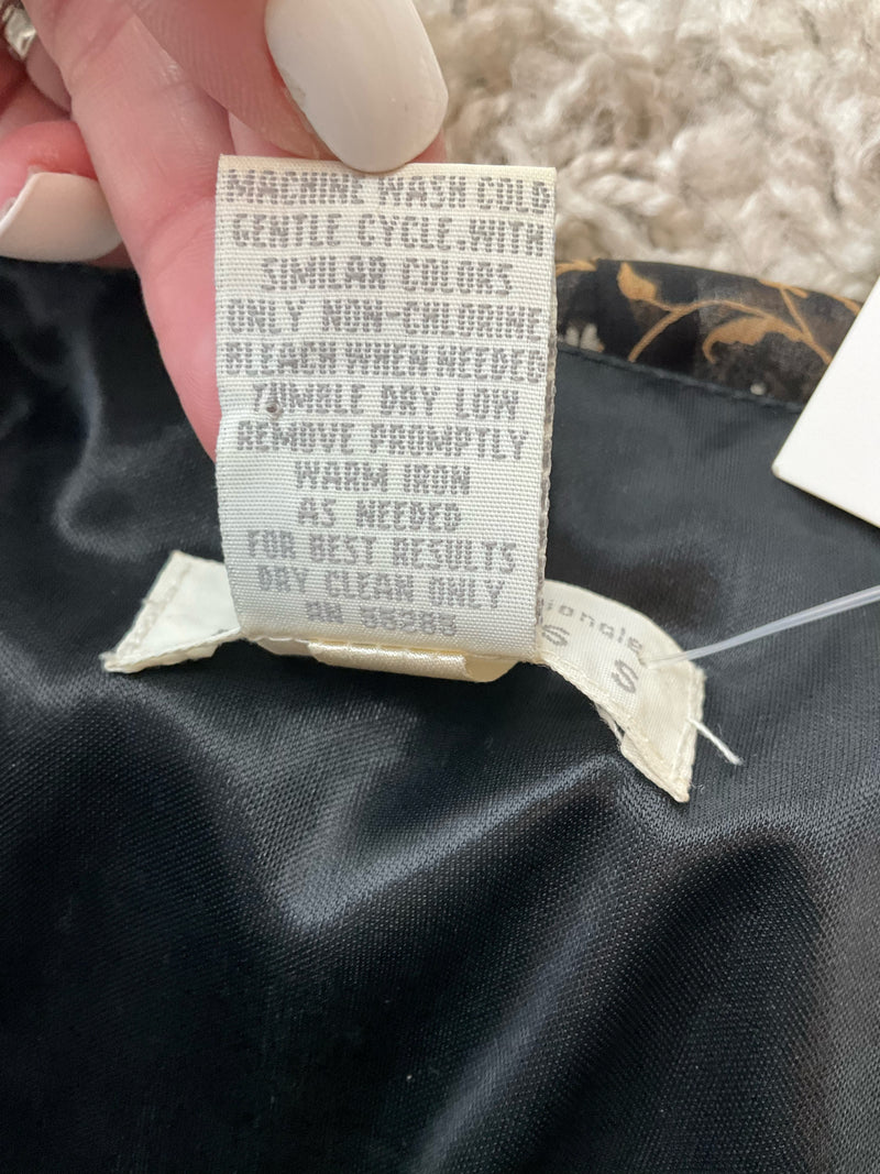 Care label of vintage Express Y2K slip dress with washing instructions and RN 56583, highlighting polyester and nylon fabric blend.