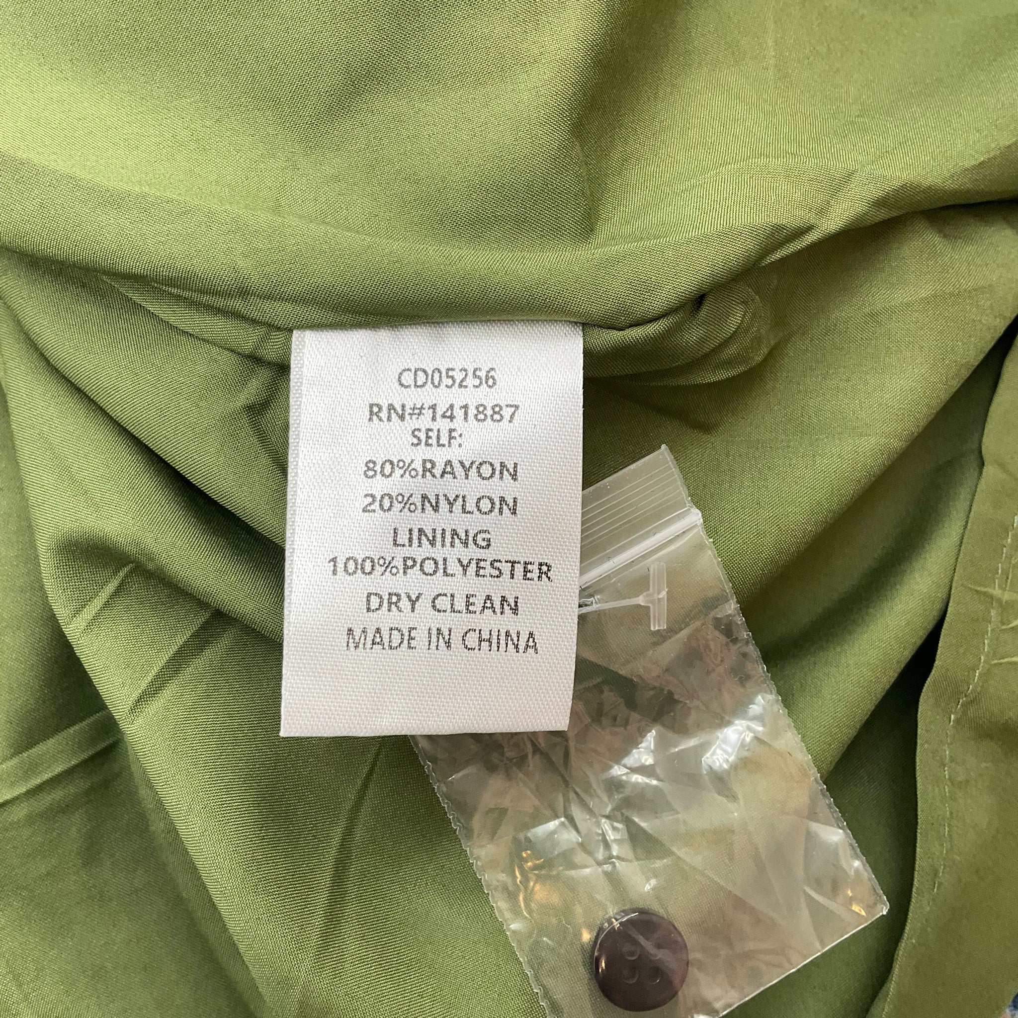 Fabric content and care label of Tcec Olive/Black Animal Print Dress - Size Large showing rayon, nylon, and polyester blend.