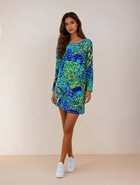 Lilly Pulitzer Dress Size Small in teal and multi-color print modeled with white sneakers, available at Margaret’s Fine Consignments.