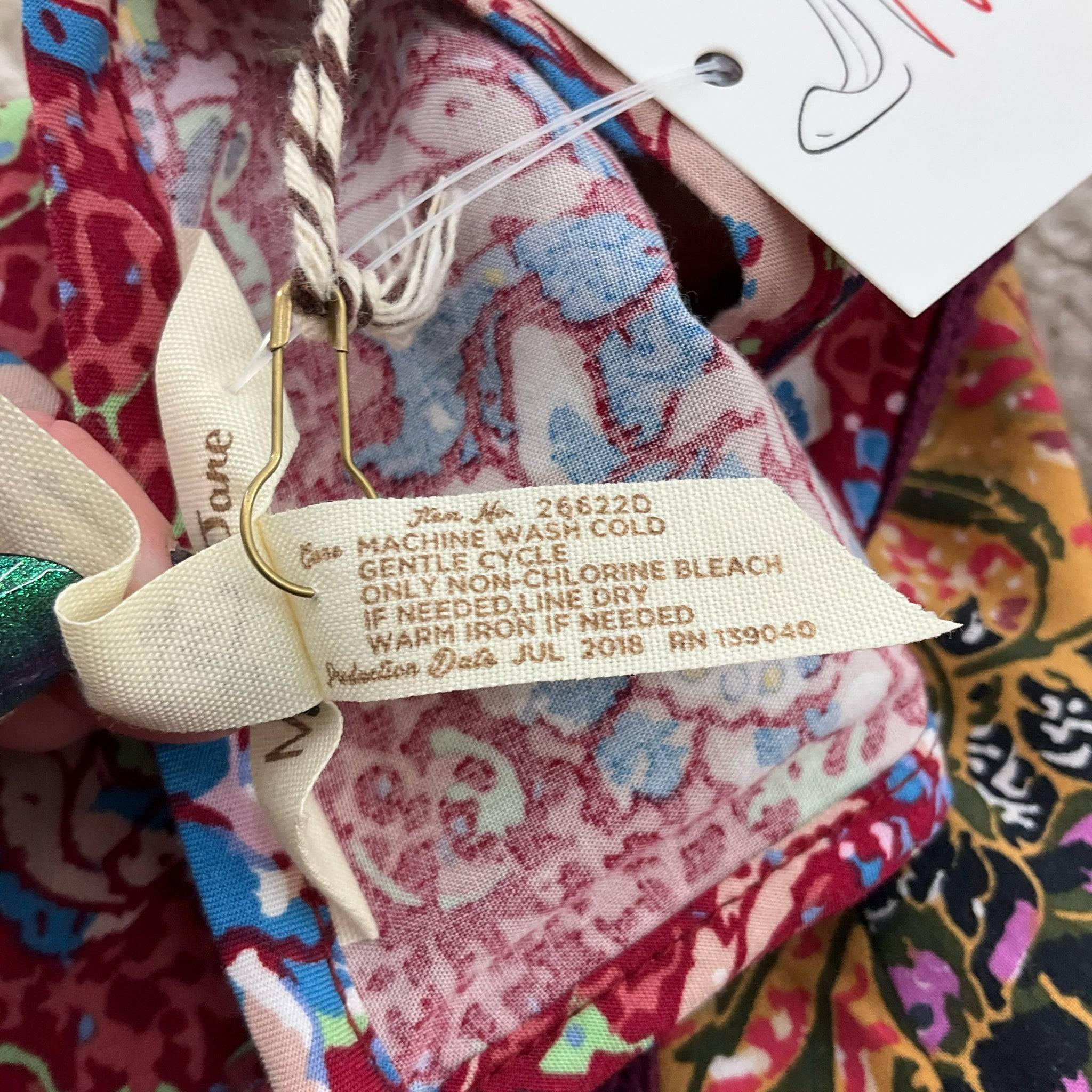 Care label for Matilda Jane maroon floral mini dress, size medium, with washing instructions. Shop at Margaret’s Fine Consignments.