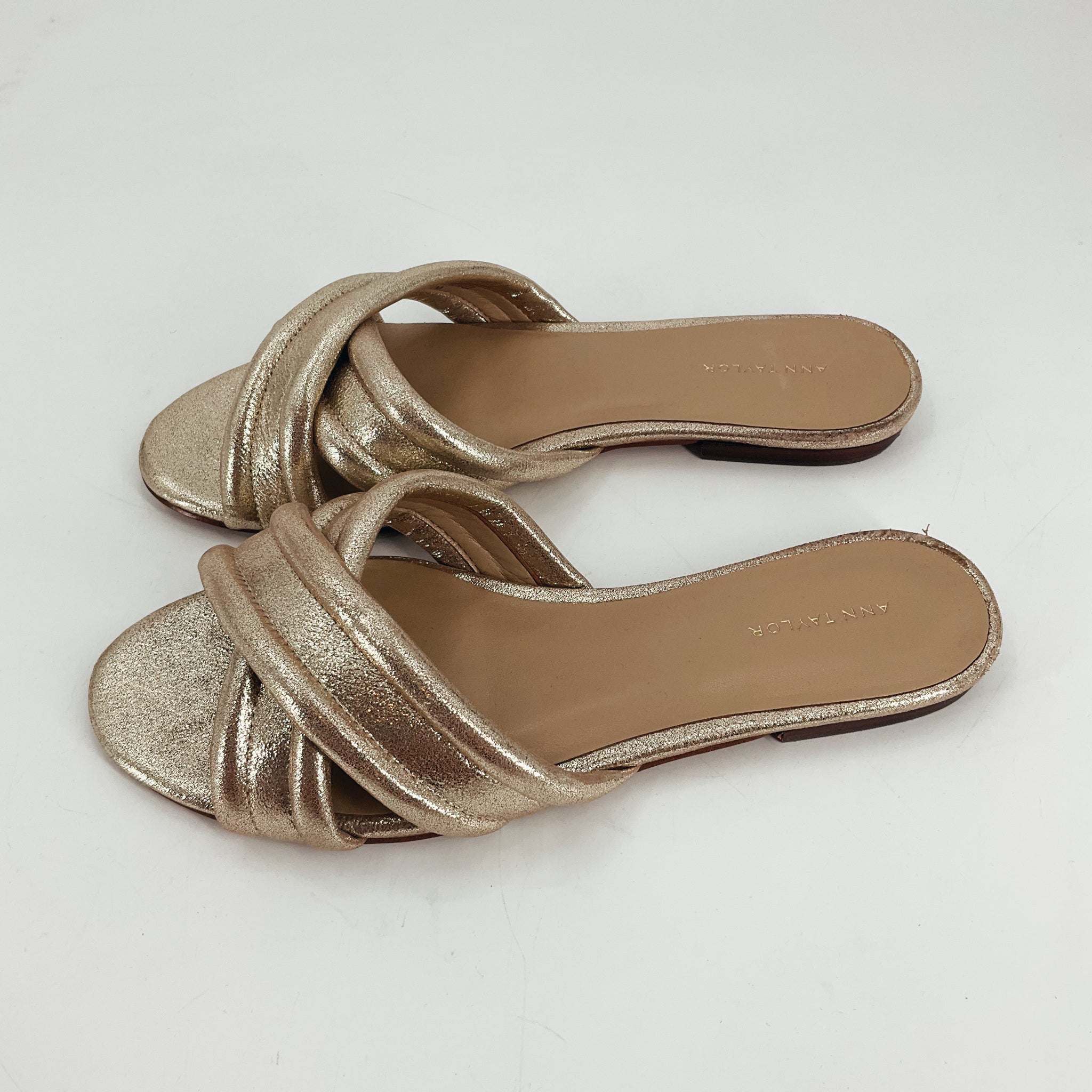 Ann Taylor Gold Sparkle Sandals - Size 7 with crisscross straps and shimmering finish, ideal for weddings or parties. Available at Margaret's.