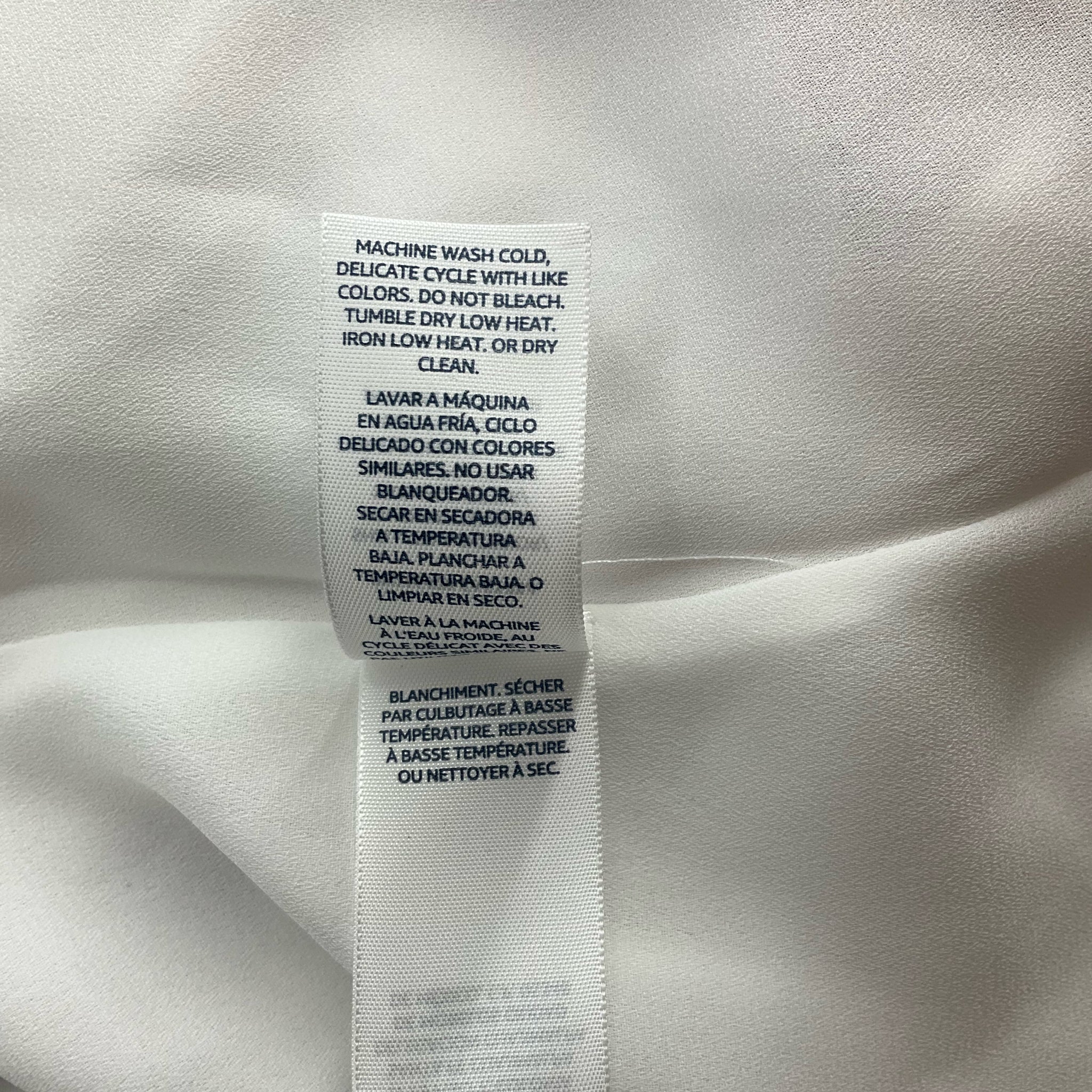 Care instructions tag for Ella Moon Mauve/White Floral Maxi Dress - Size Large, machine washable with delicate cycle. Easy-care pre-owned dress.