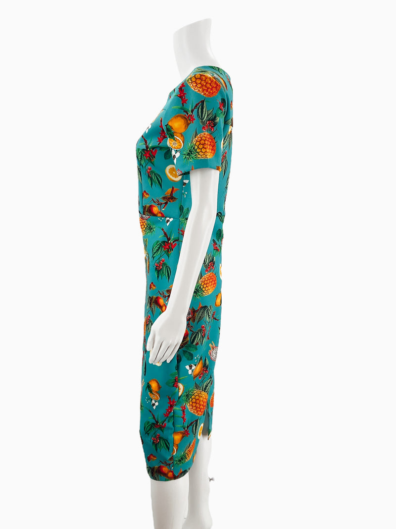 Side profile of Alexia Admor turquoise fruit print sheath dress on mannequin, showcasing fitted silhouette and short sleeves, size small.