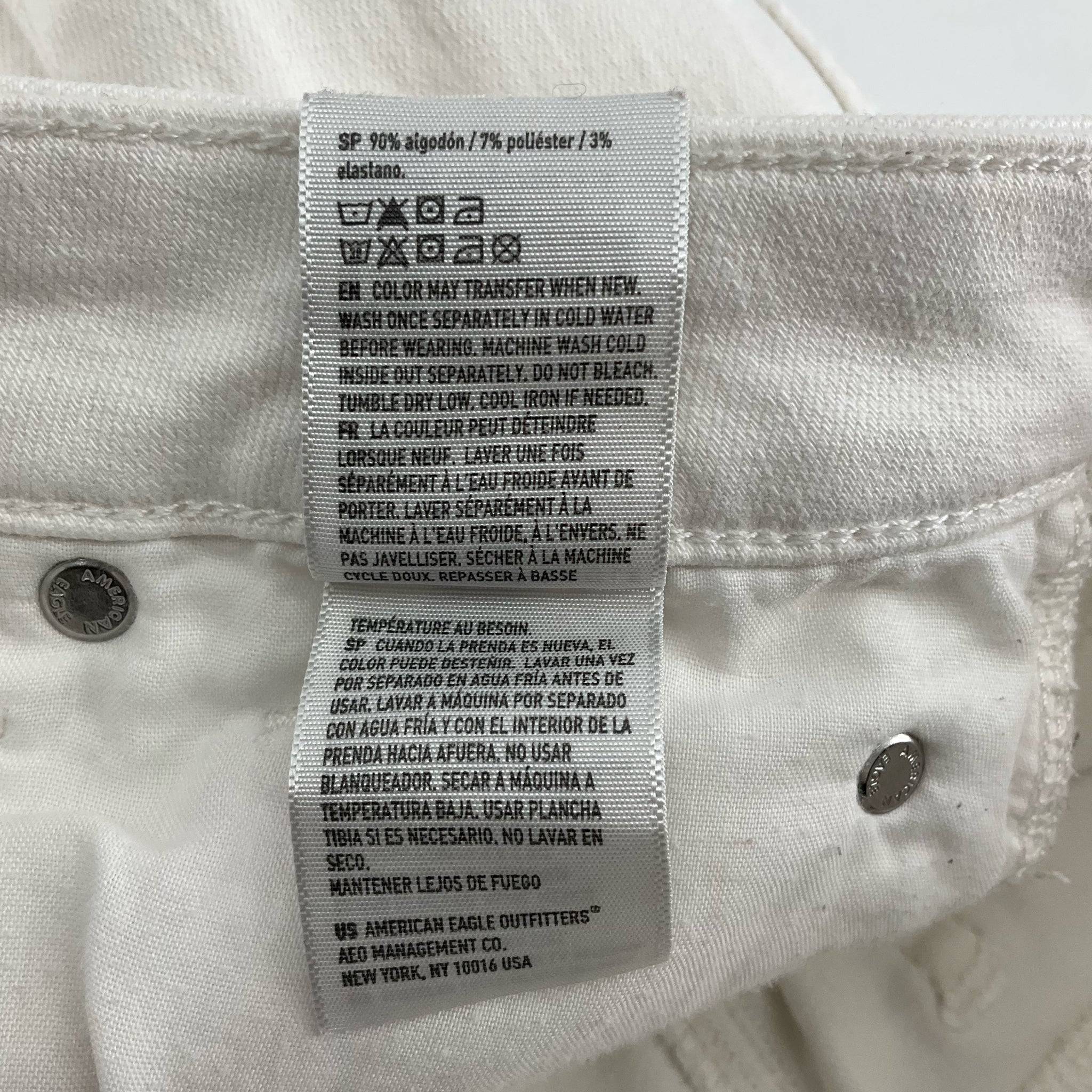 Detailed fabric care instructions for american eagle Size 4 White ripped Shorts, including washing and drying guidelines.
