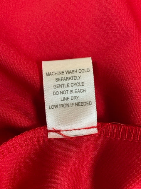 Care label for Emma Michele red dress indicating machine wash cold, gentle cycle, and line dry instructions.