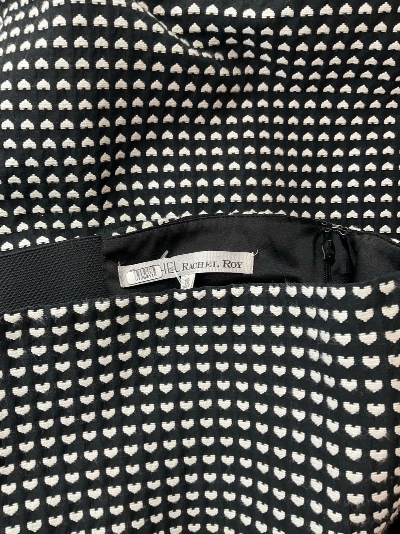 Close-up of Rachel Roy dress label inside the black and white heart jacquard mini dress, confirming brand authenticity and size 10.
