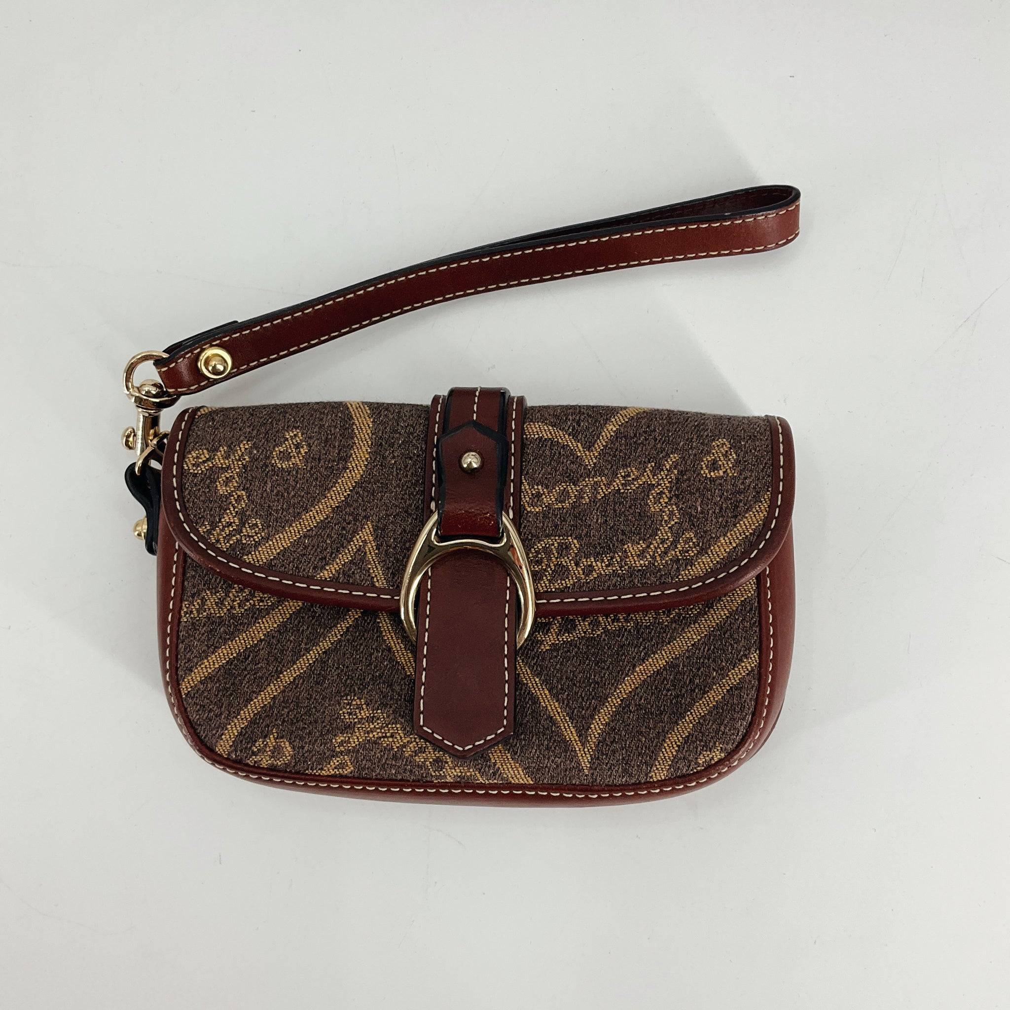 Dooney & Bourke Brown Pre-Owned Wristlet with monogram canvas and leather trim, available at Margaret’s Fine Consignments. Compact and stylish design.