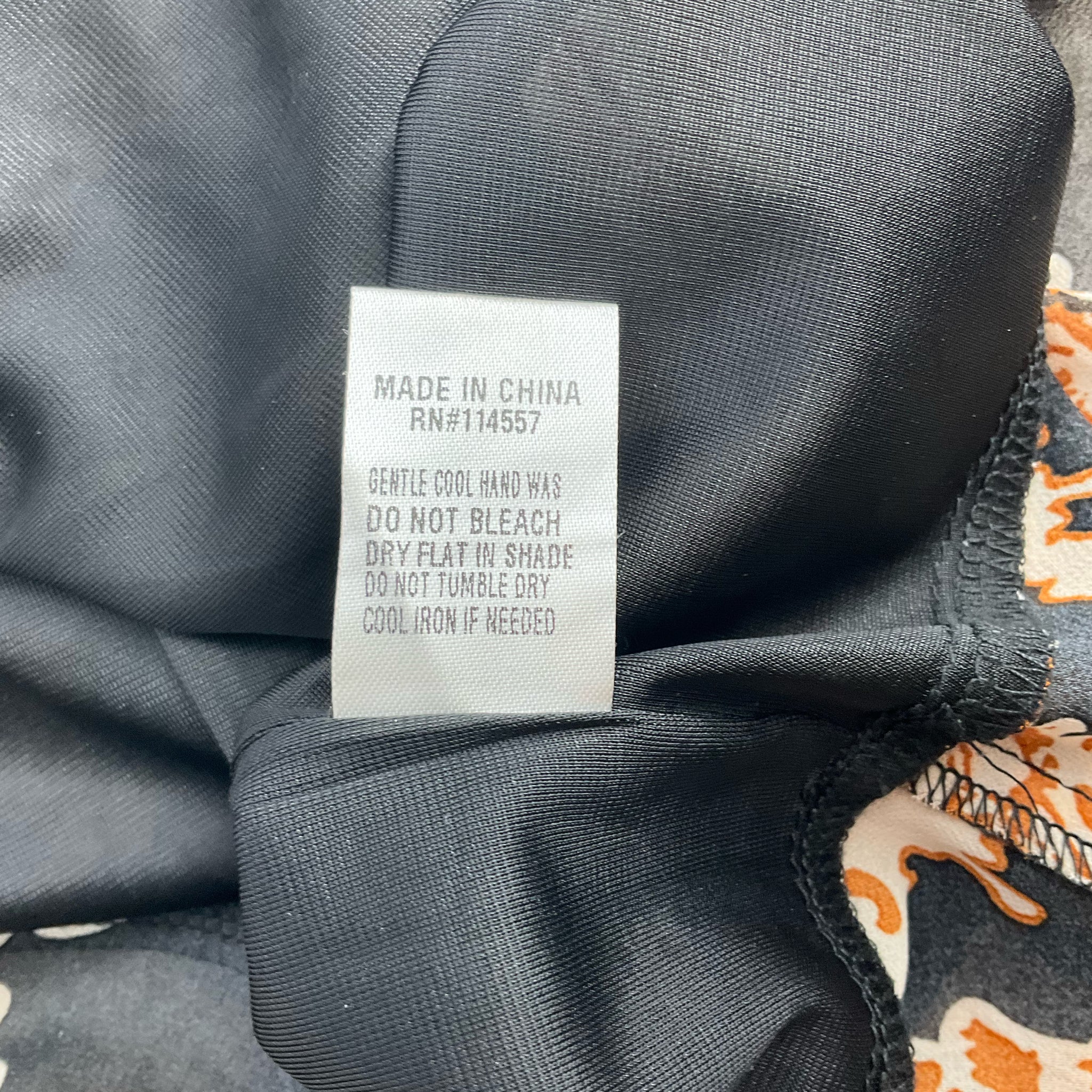 Care label of THML Black/Camel Flora Dress - Size Small with washing instructions, made in China, pre-owned and available at Margaret’s Fine Consignments.