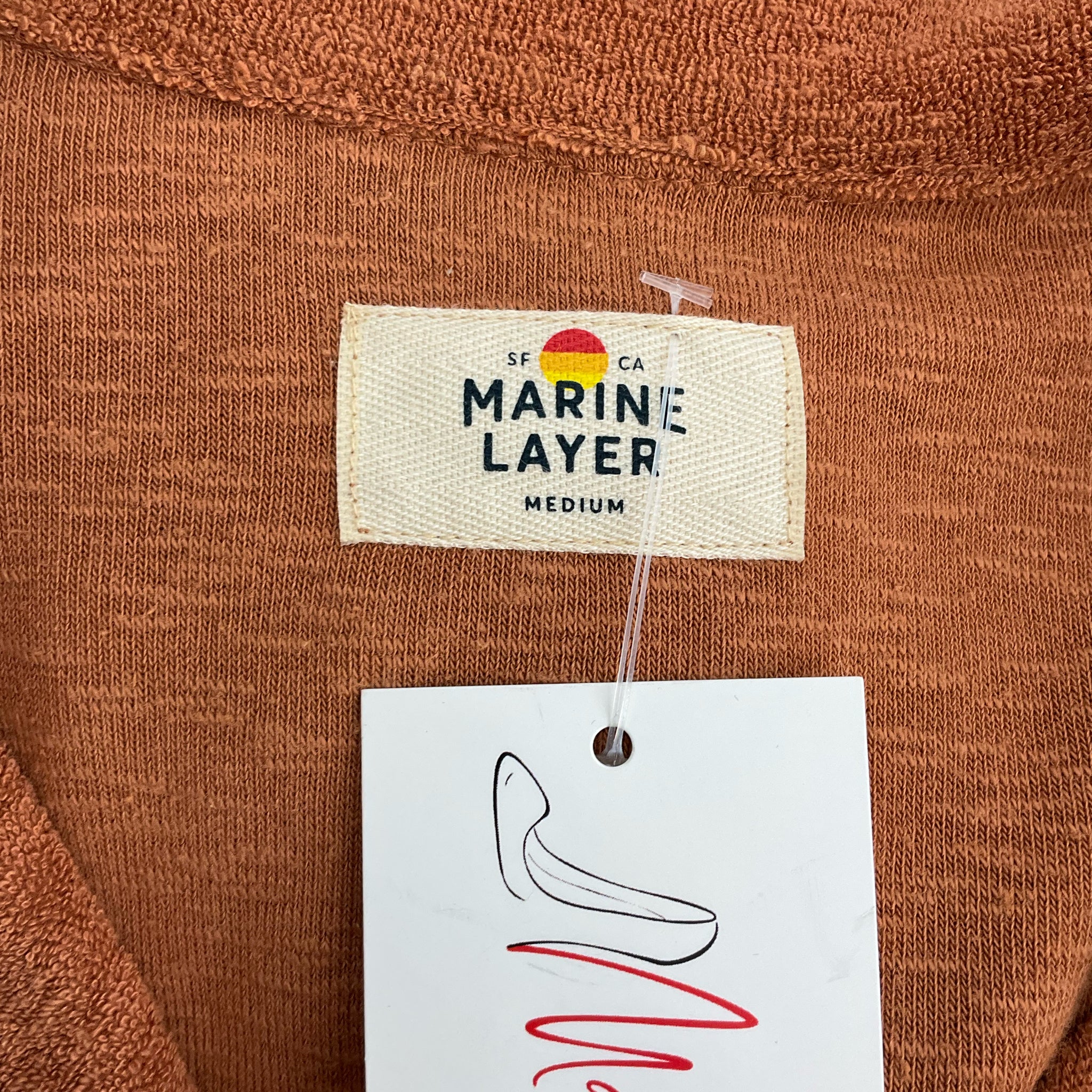 Close-up of Marine Layer brand tag on Rust 2 Piece Set Size Medium, highlighting brand authenticity and medium sizing.