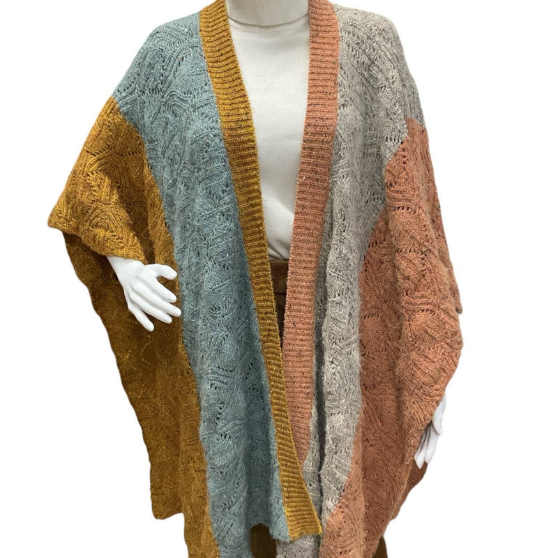 Sundance Shrug Size XS/S draped on mannequin over turtleneck, highlighting cozy multi-colorblock pattern. Shop gently used at Margaret’s Fine Consignments.