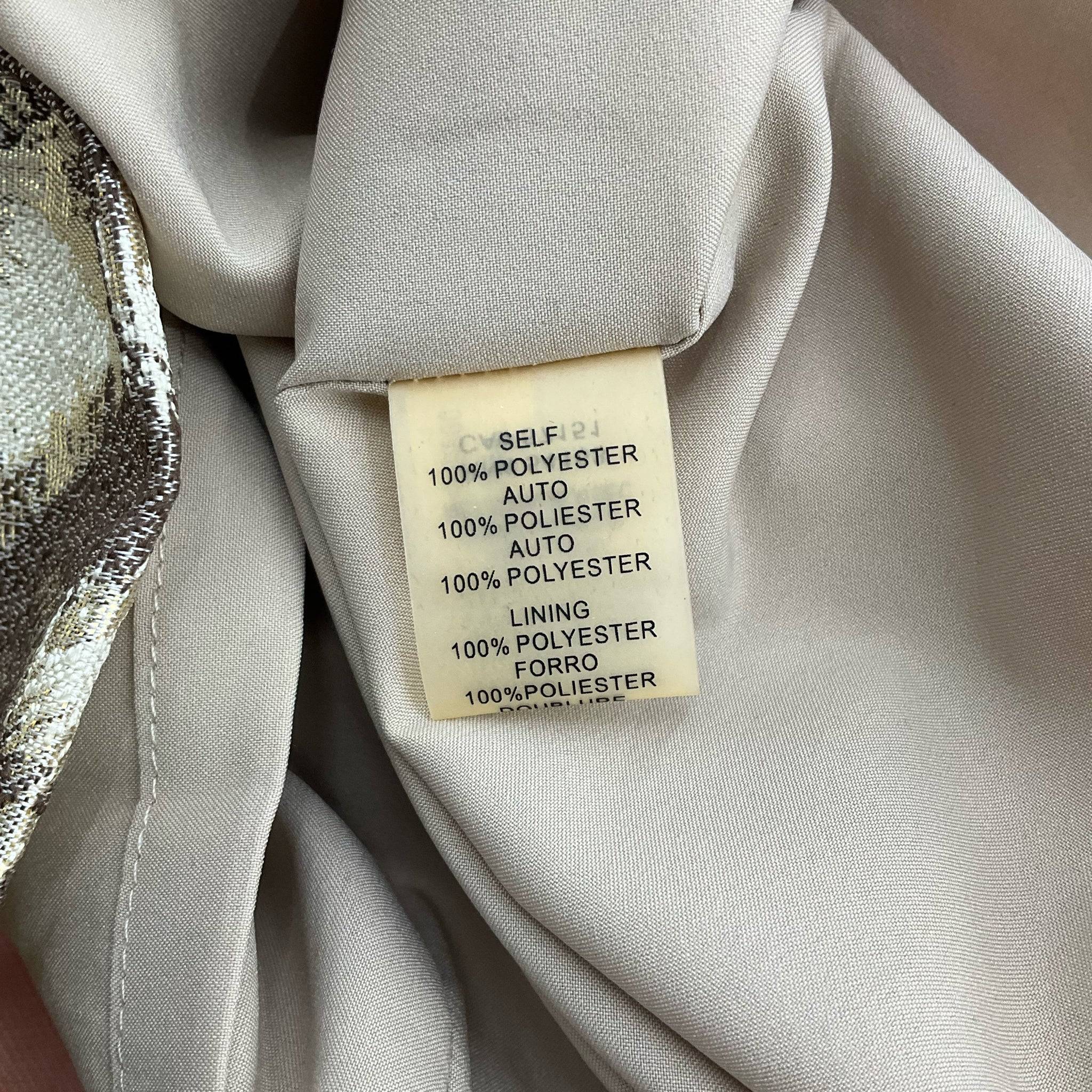 Fabric content tag of Vince Camuto Sparkle Mini Dress indicating 100% polyester for both shell and lining.