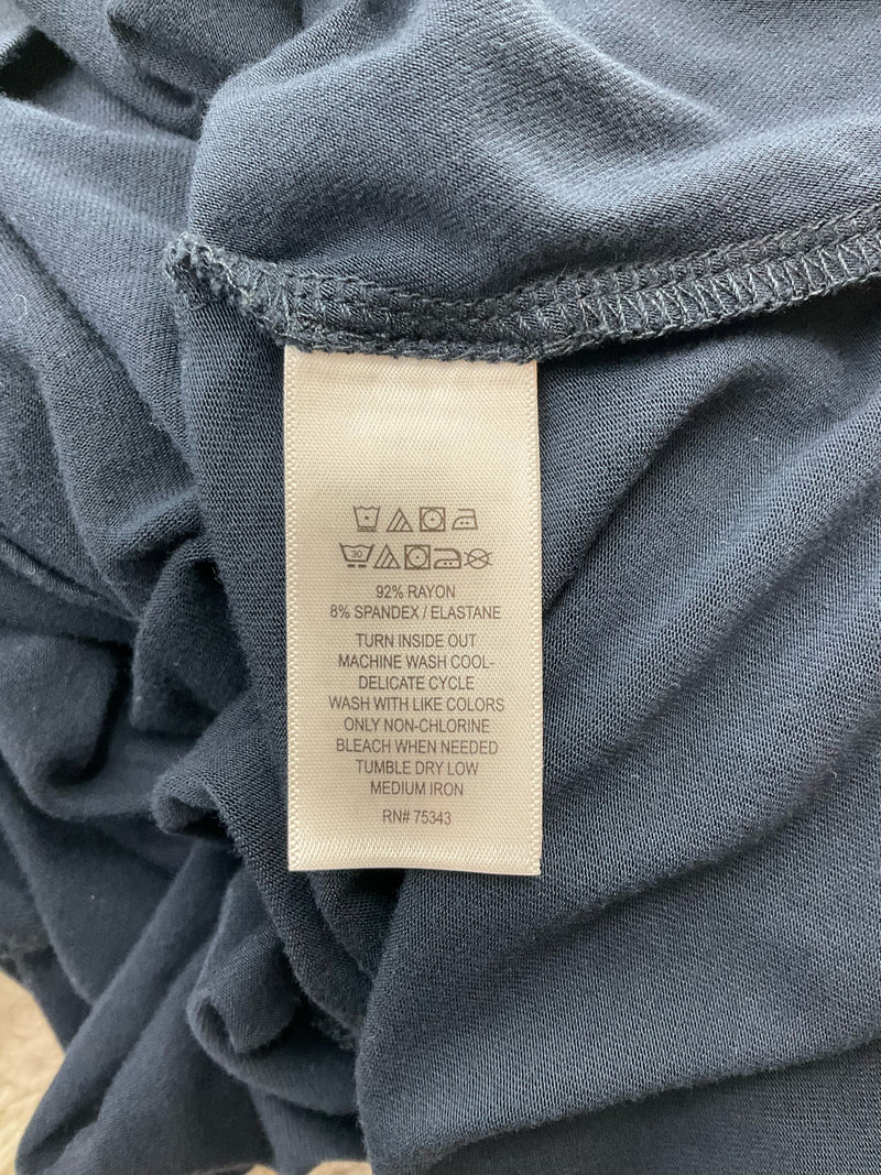 Fabric care label of C&C California navy dress showing 92% rayon and 8% spandex blend with washing instructions and RN 75343.