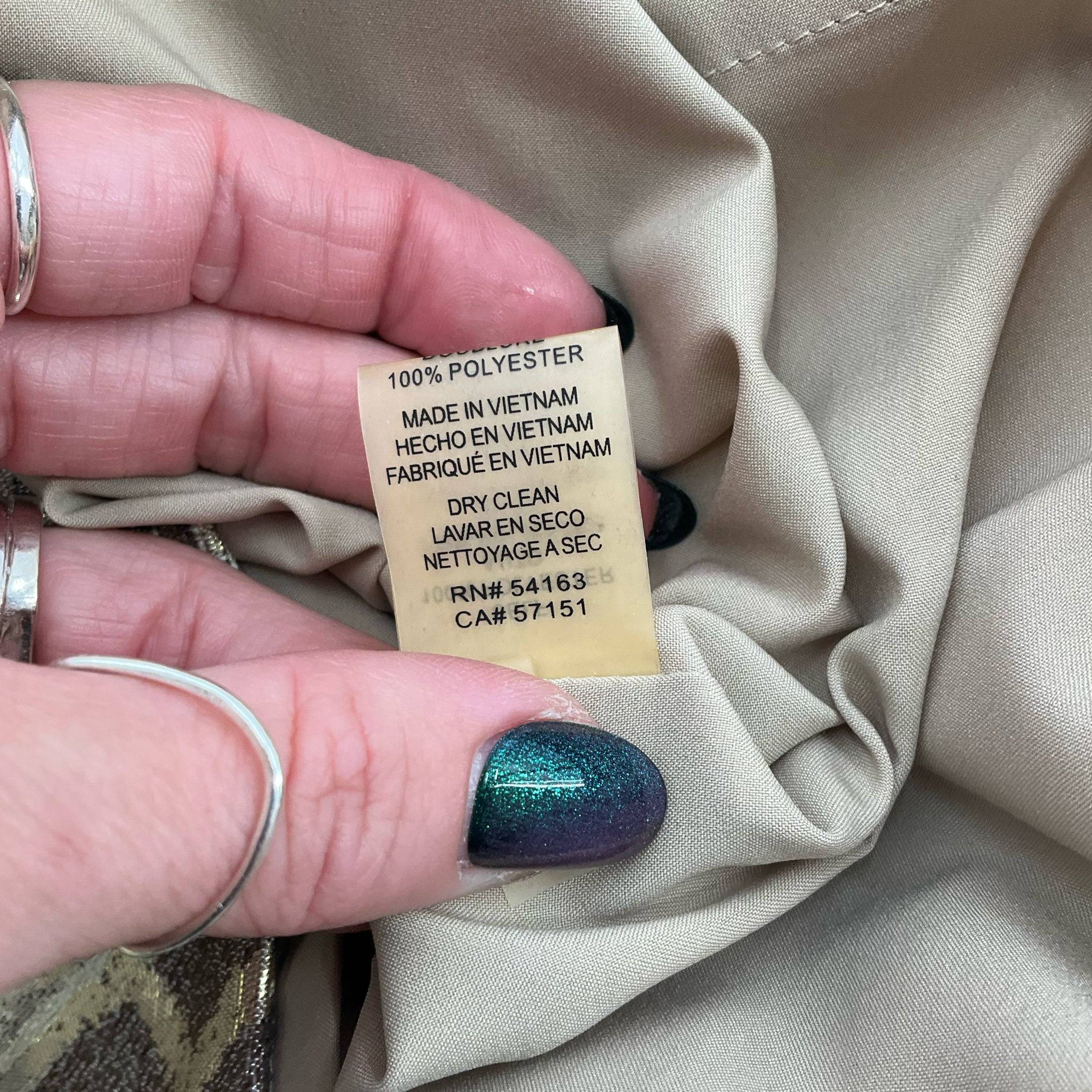 Care label of Vince Camuto Sparkle Mini Dress showing dry clean instructions and manufacturing details.