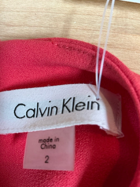 Brand label of Calvin Klein Coral Pre-Owned Ladies Dress - Size 2, made in China, confirming designer origin and size for resale listings.