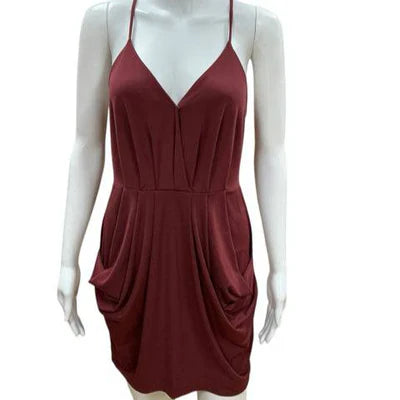 BCBG maroon solid ladies dress in size small, showcasing elegant design and fabric texture. Pre-owned condition.