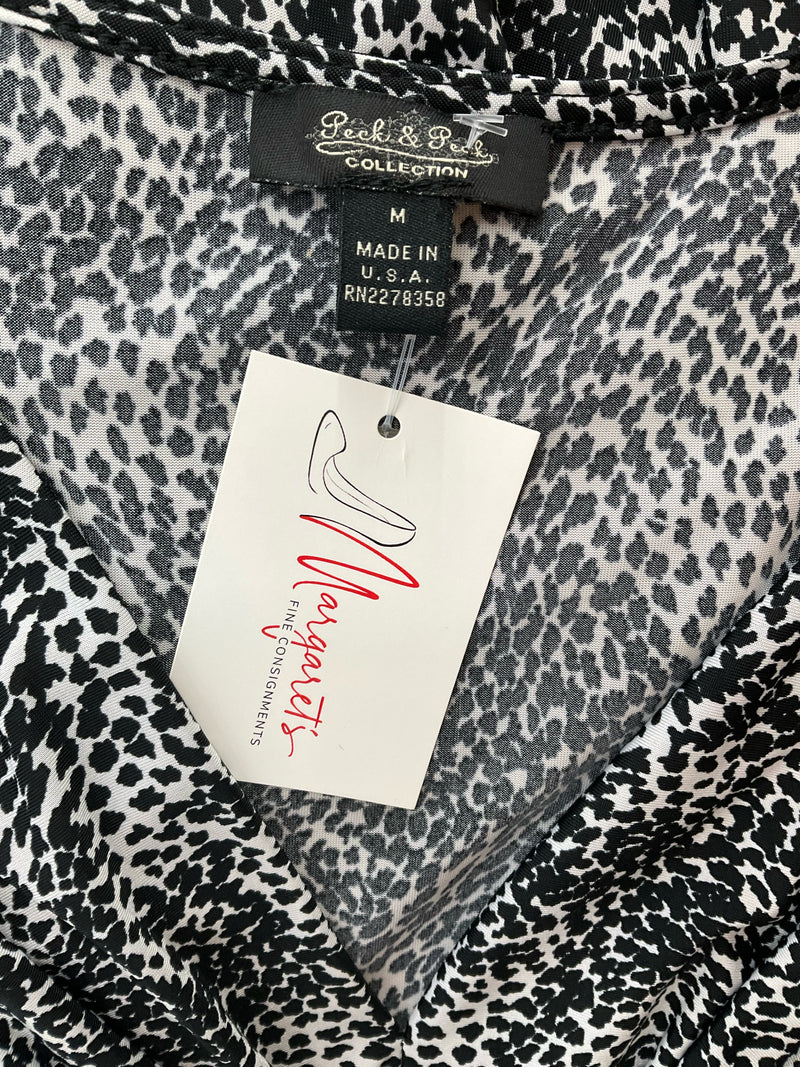 Close-up of Peck & Peck Collection label on black and white animal print dress, size medium, made in the USA with consignment tag.